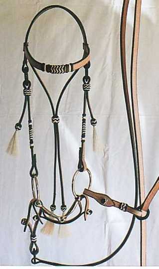 natural bring2-1.jpg - Custom
Straight Brow braided ring Bridle. Natural with Balck & White Kangaroo hide knots, white horse hair tassels
Matching button Curb strap
Split reins with braided ring & button attachment.
